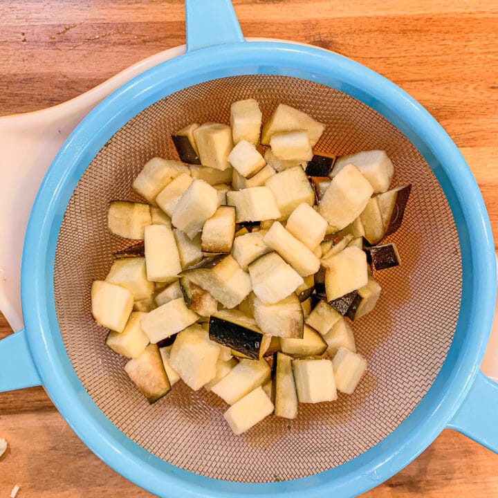 cubed eggplant in a colander
