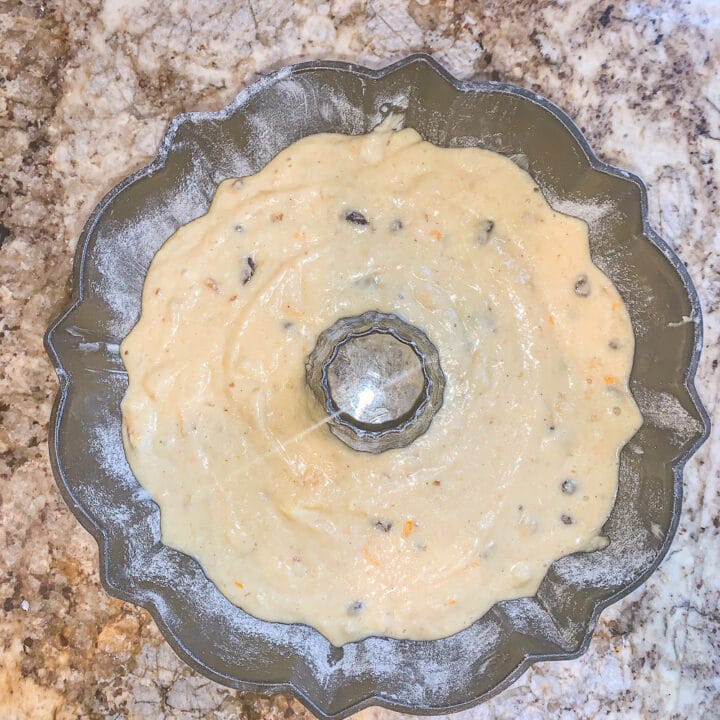 orange cake batter in a bundt pan