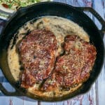 grilled ribeye steaks in a cast-iron skillet