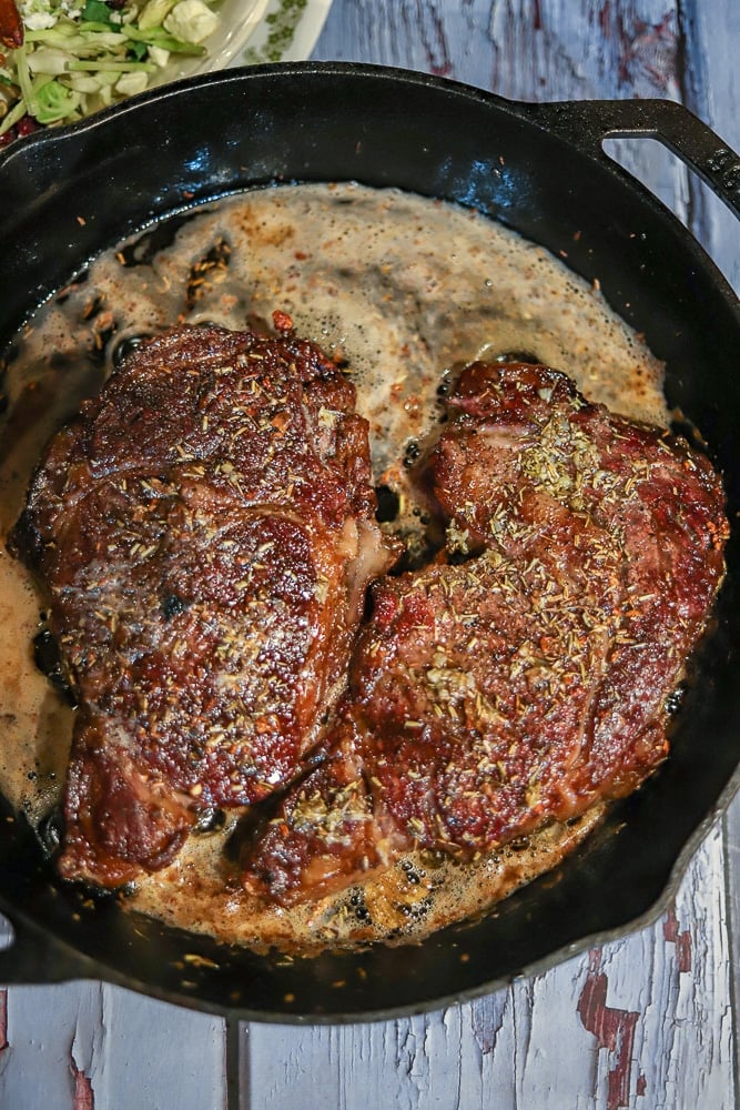 Grilled Ribeyes in a cast-iron skillet