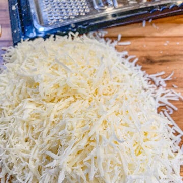 finely shredded cheese with a grater in the background
