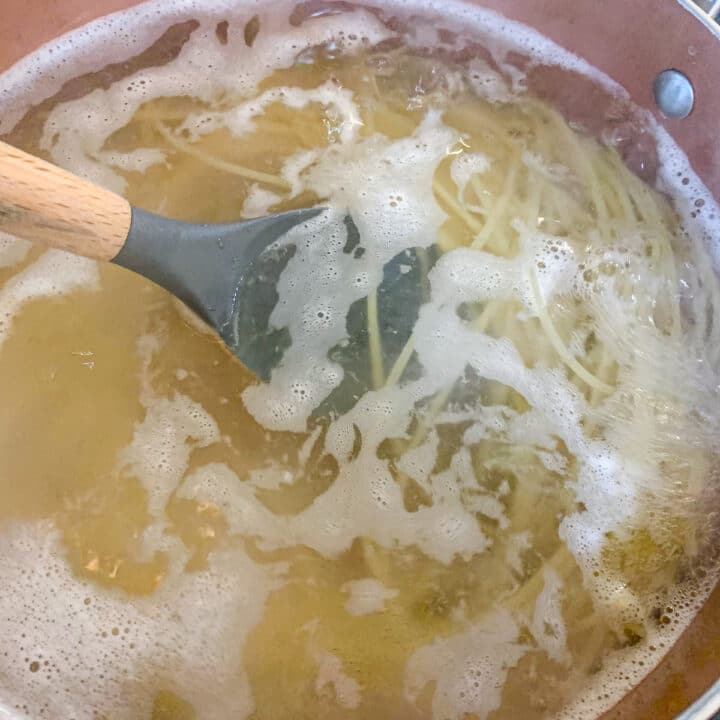 stirring pasta in water