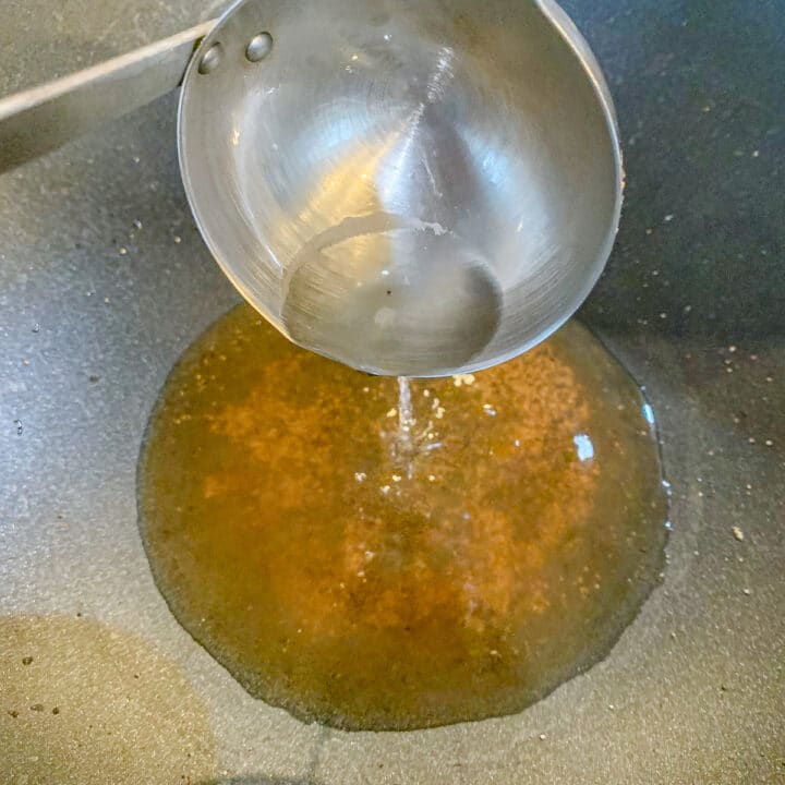 adding water to a pan 