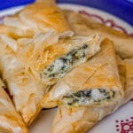 spanakopita stacked on a plate