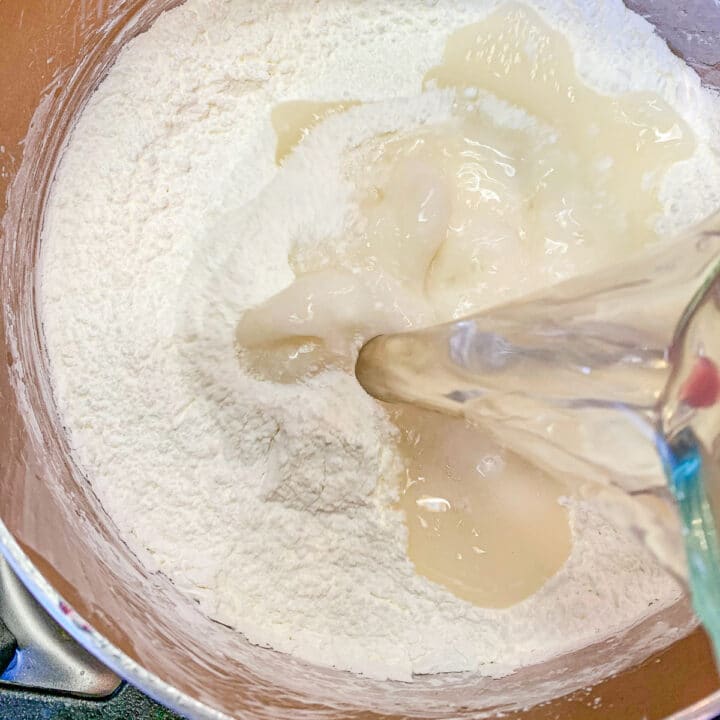 adding liquid to a pot of sugar