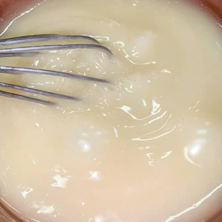 whisking thick mixture in a pot