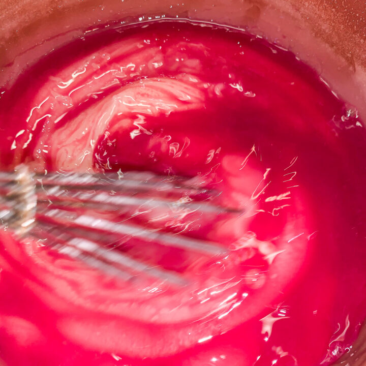 whisking red mixture in a pot
