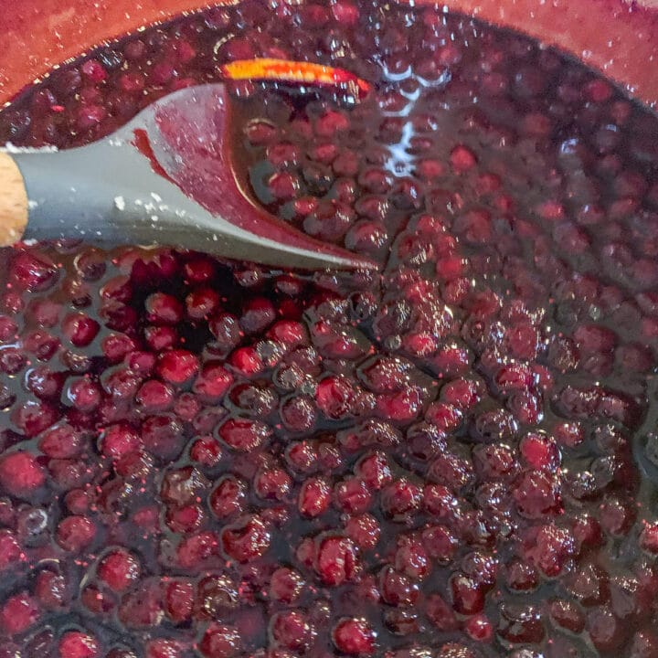 stirring berries in a pot
