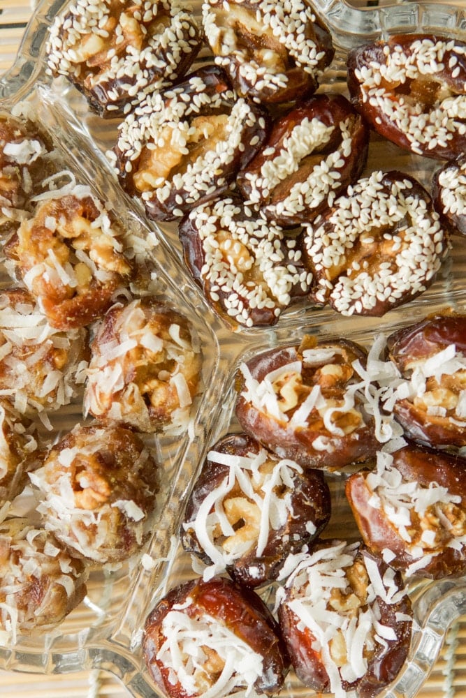 dates stuffed with nuts and covered with shredded coconuts and sesame seeds