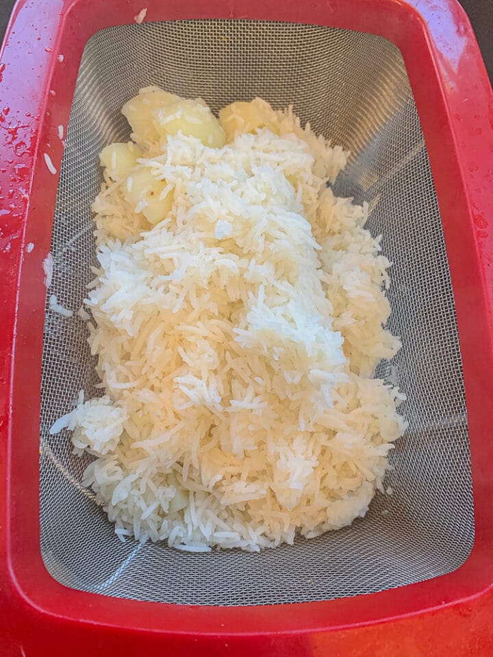 rice and potatoes draining in a colander
