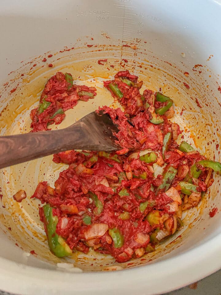 tomato paste, onions, and pepper being sautéed