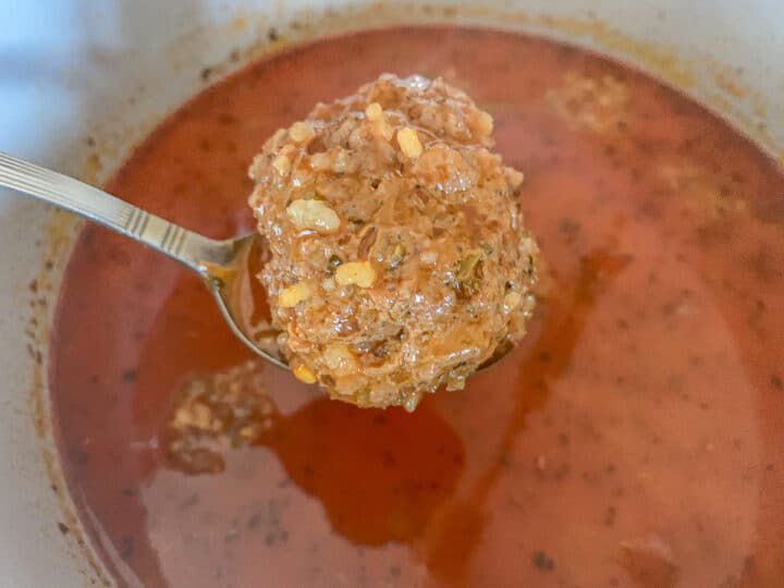 removing meatball from soup