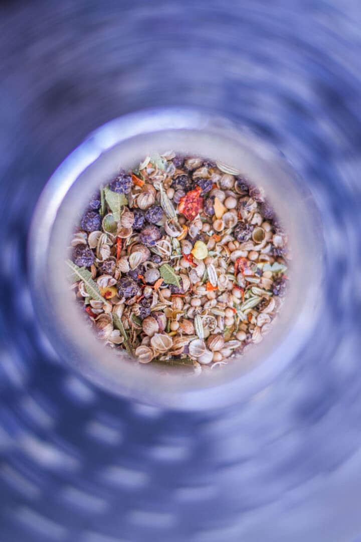 corned beef spices in a jar with a blue background