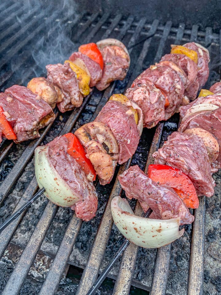 skewered lamb and vegetables on the grill