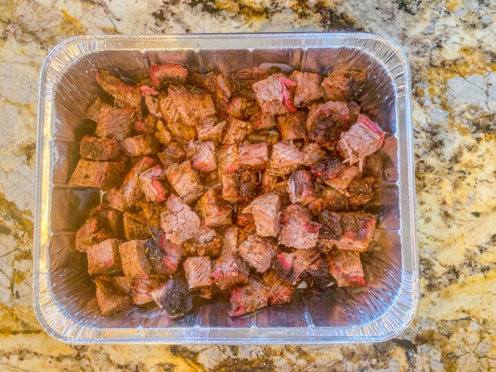 cubed burnt ends in a pan