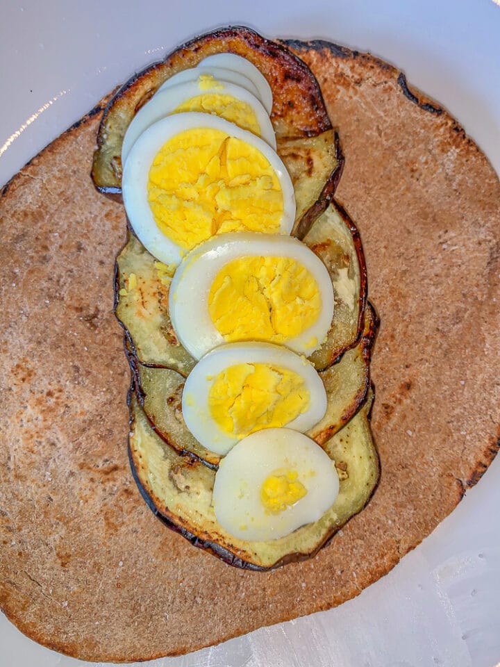 pita bread with sliced eggplant and boiled eggs