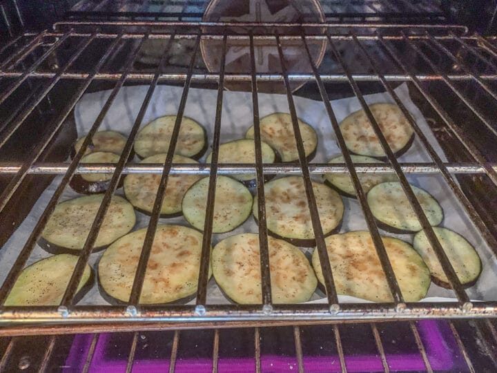 sliced eggplant on a tray in the oven