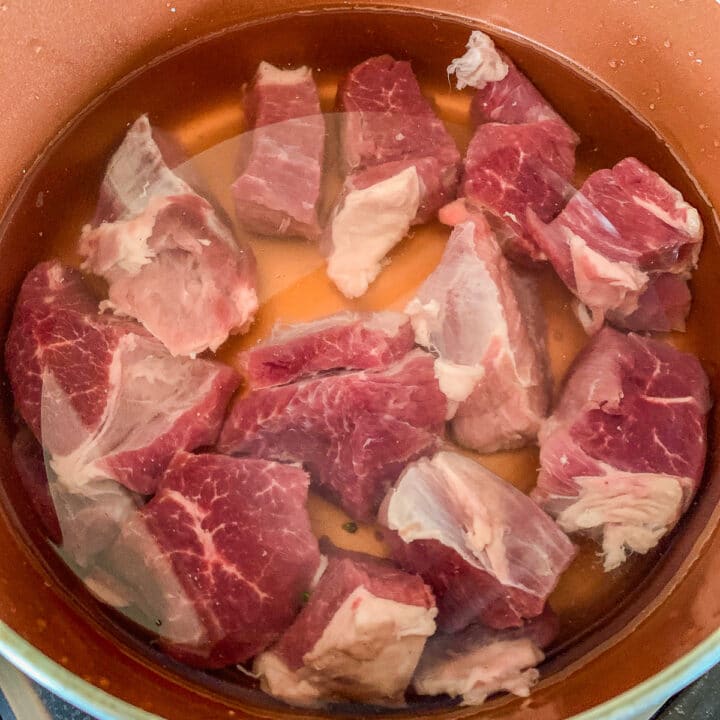 chopped lamb in a pot of water