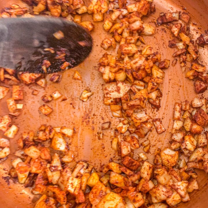 diced onion and paprika being cooked