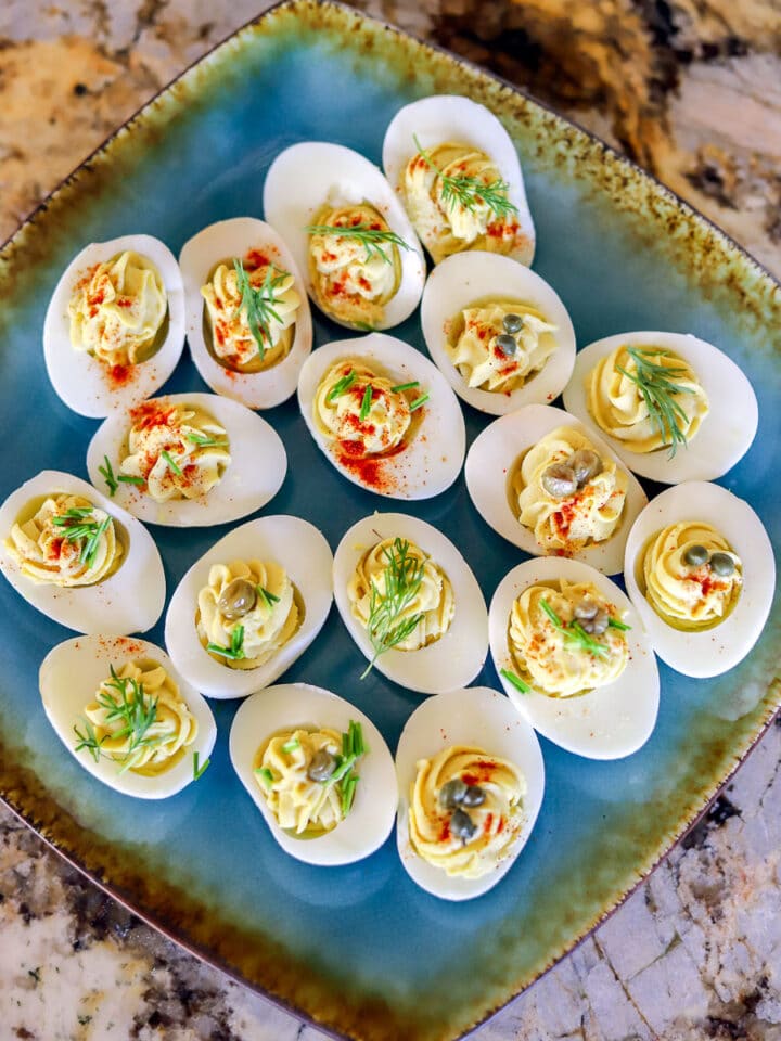 keto deviled eggs garnished with dill and capers