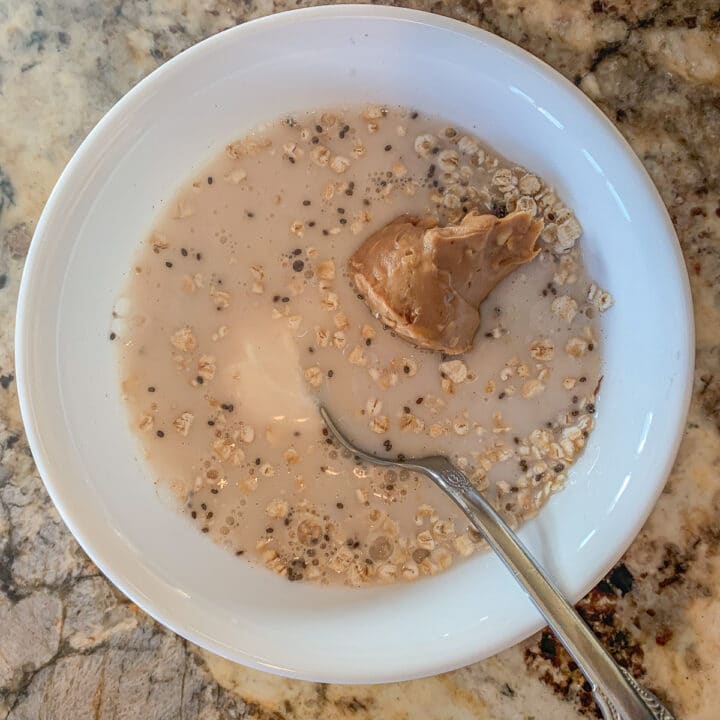 making protein overnight oats in a white bowl