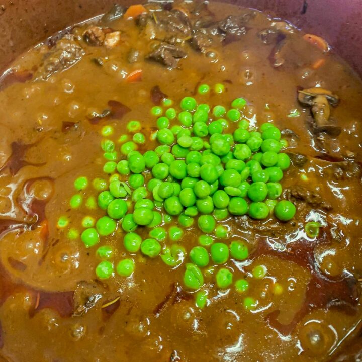 stew topped with peas