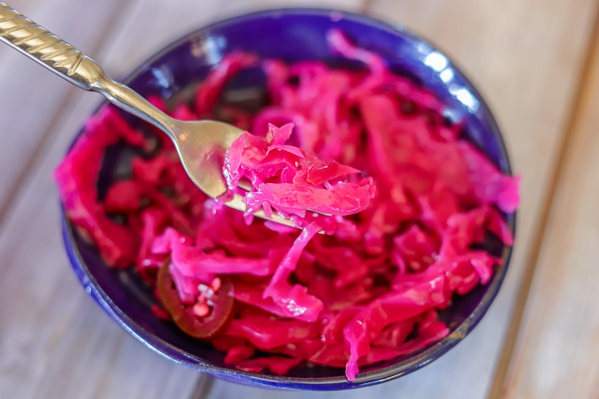 red pickled cabbage in a blue bowl