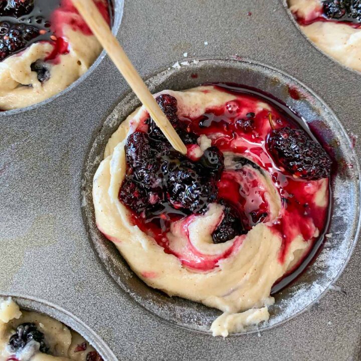 swirling mulberry jam into muffin batter