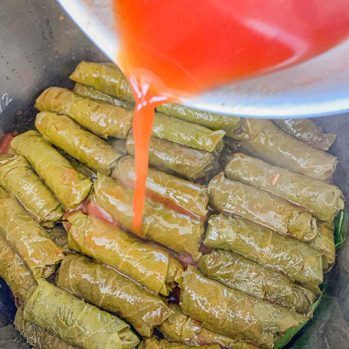 pouring sauce over dolma