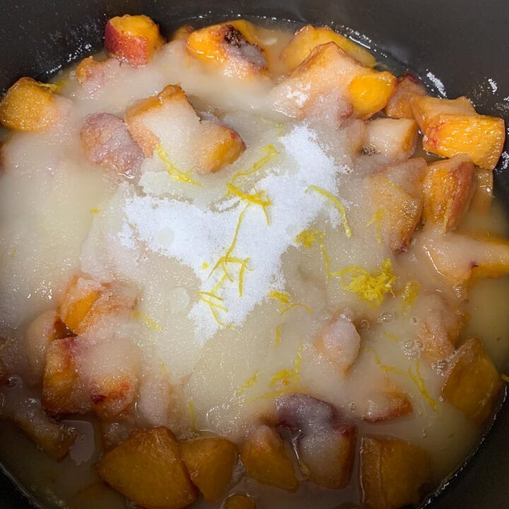 chopped peaches covered with sugar, lemon, zest