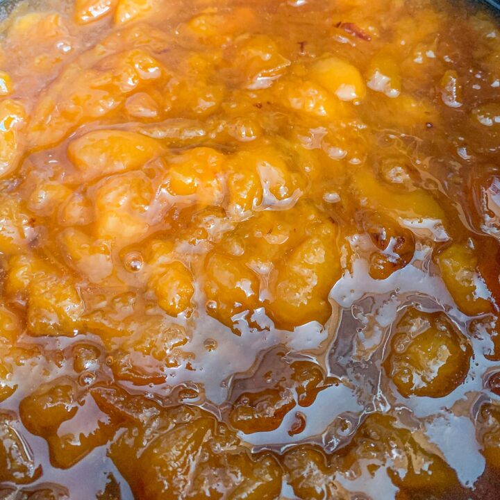 peach preserves being cooked in a pot