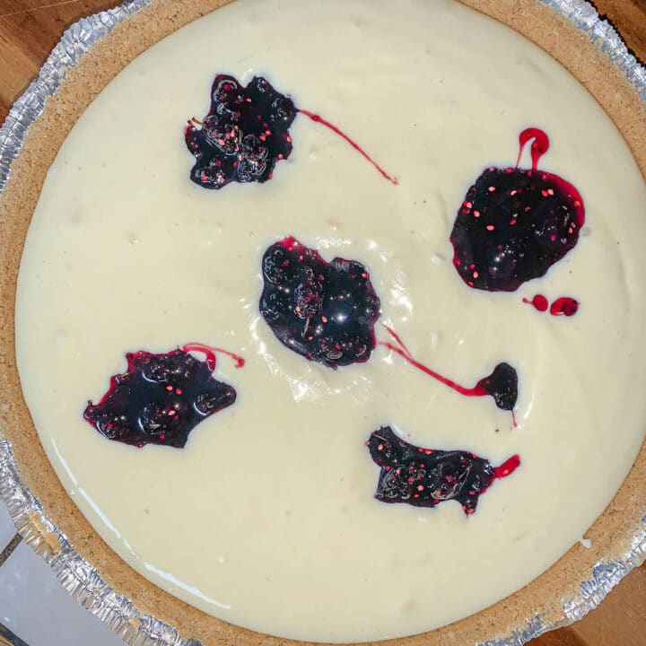 unbaked cheesecake with mulberry topping dollops