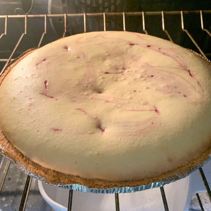 mulberry cheesecake cooling in the oven
