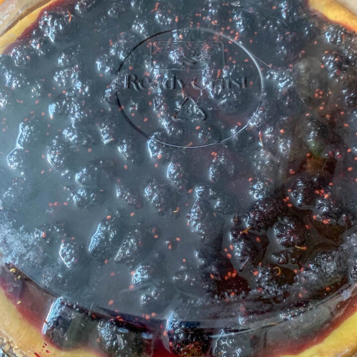 mulberry cheesecake covered with plastic lid