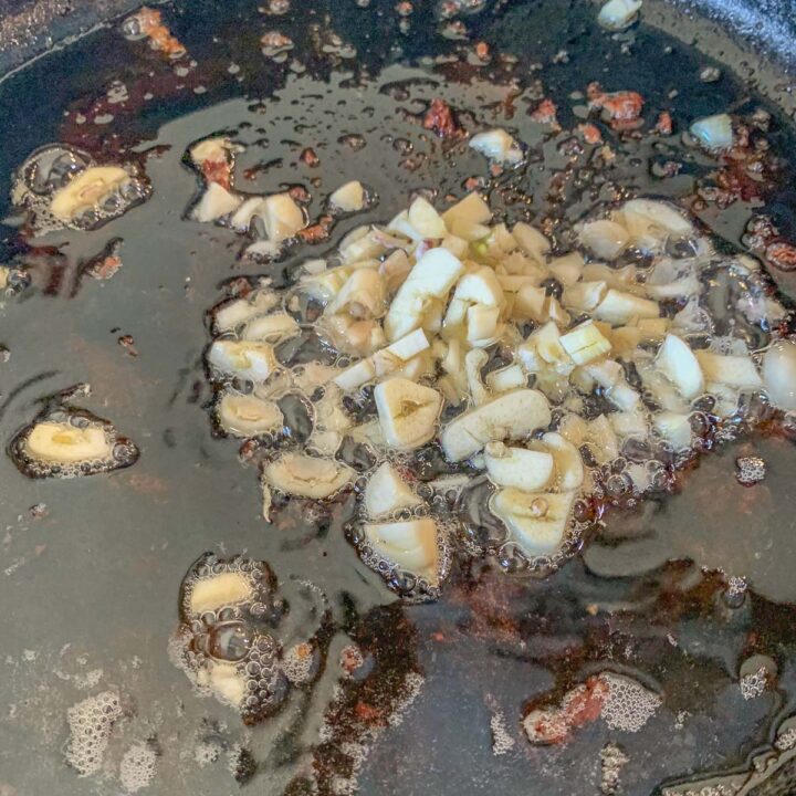 garlic being fried in a pan