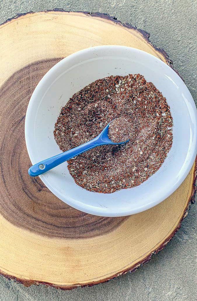 coffee rub in a bowl over a wooden slab