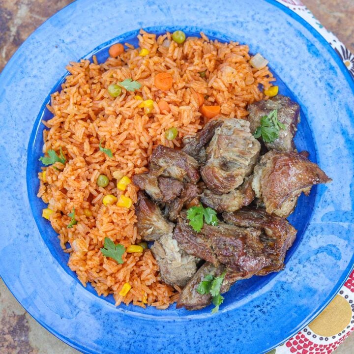 carnitas and Spanish rice on a blue plate
