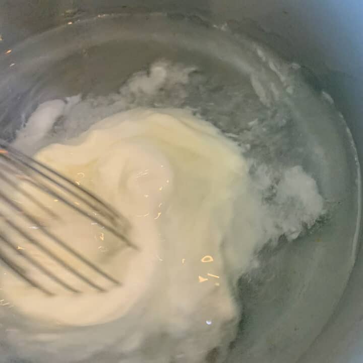 whisking yogurt in pot
