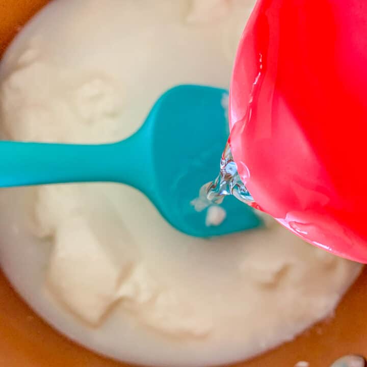 pouring water into a pot of yogurt