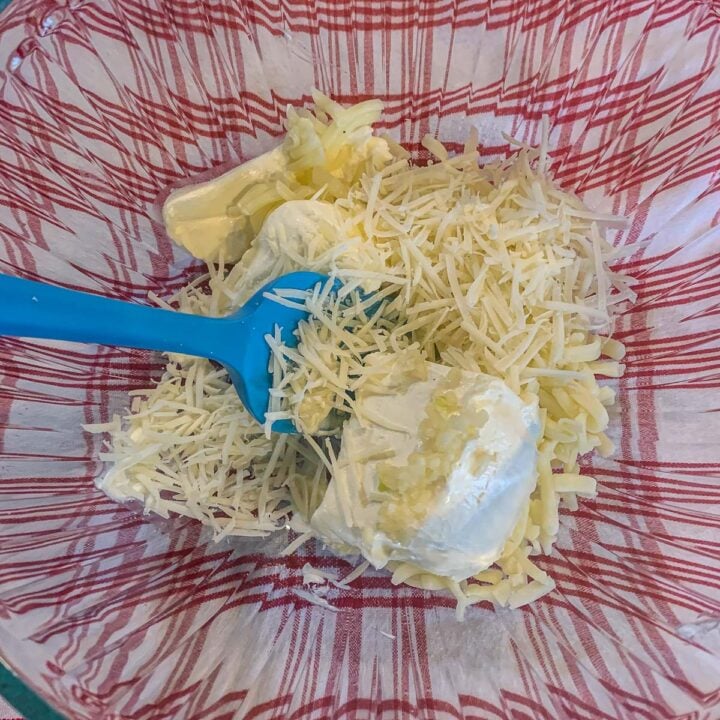 mixing cheeses in a bowl