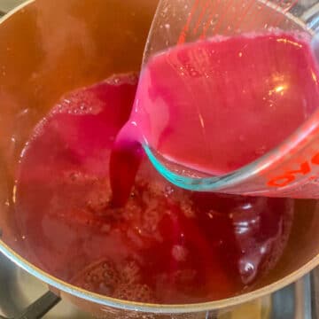 pouring chokecherry juice into a pot