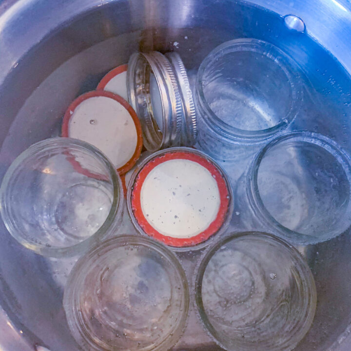 a pot of jars being sterilized in boiling water