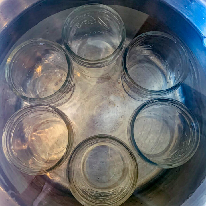 a pot of jars being sterilized in water