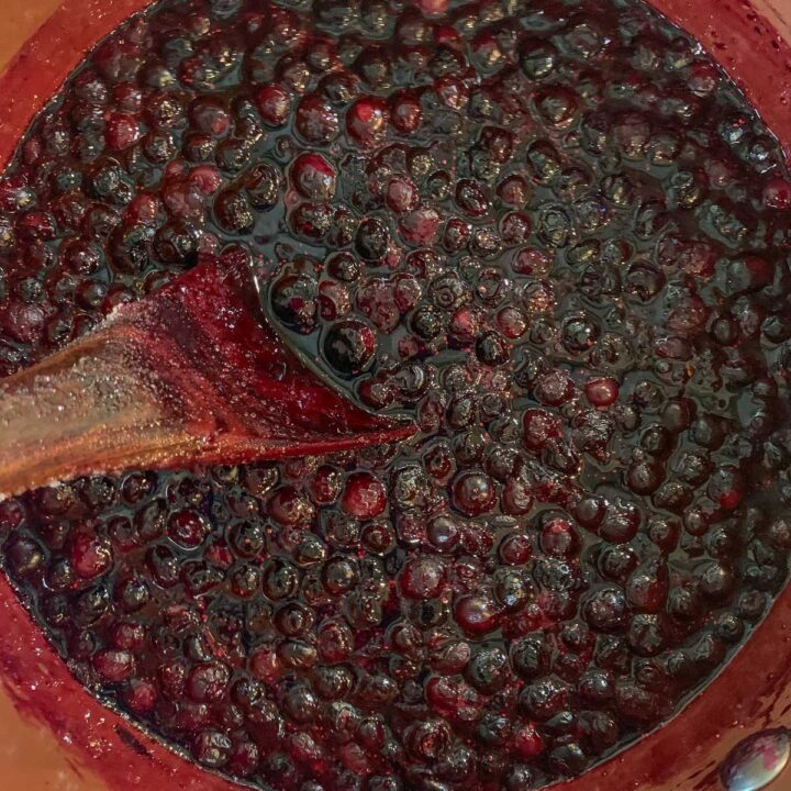 stirring huckleberry jam