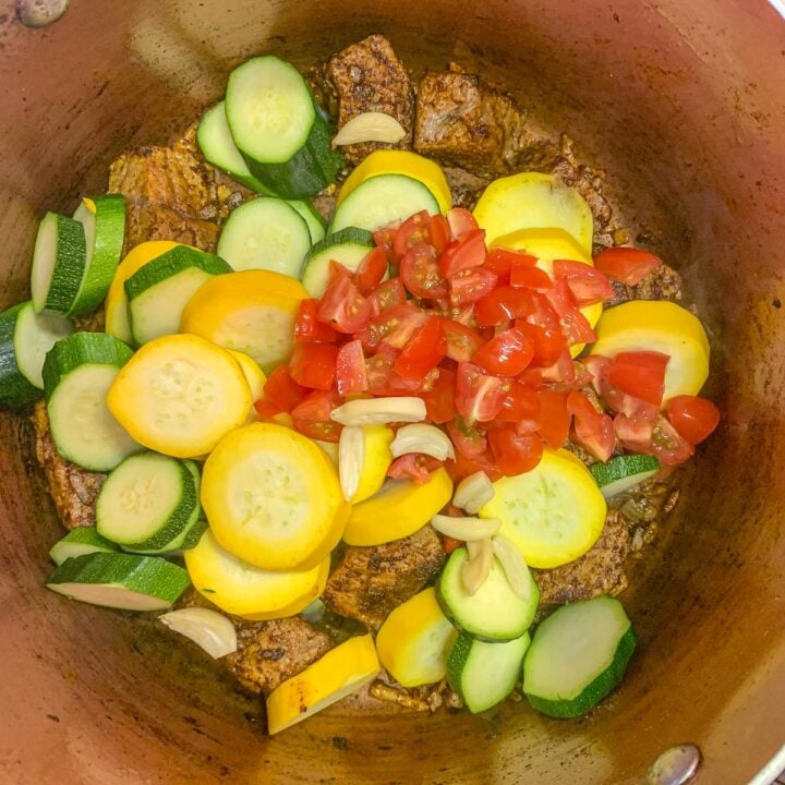 sliced veggies and meat in a pot