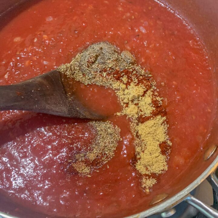 stirring spices into salsa Rojas