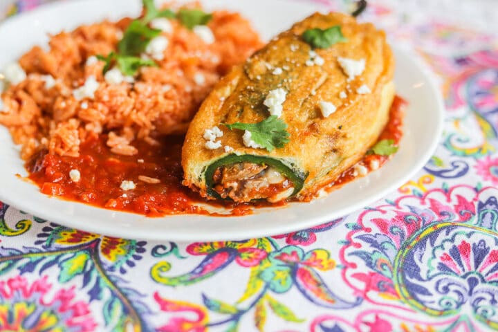 Chile Relleno on a white plate with Mexican rice