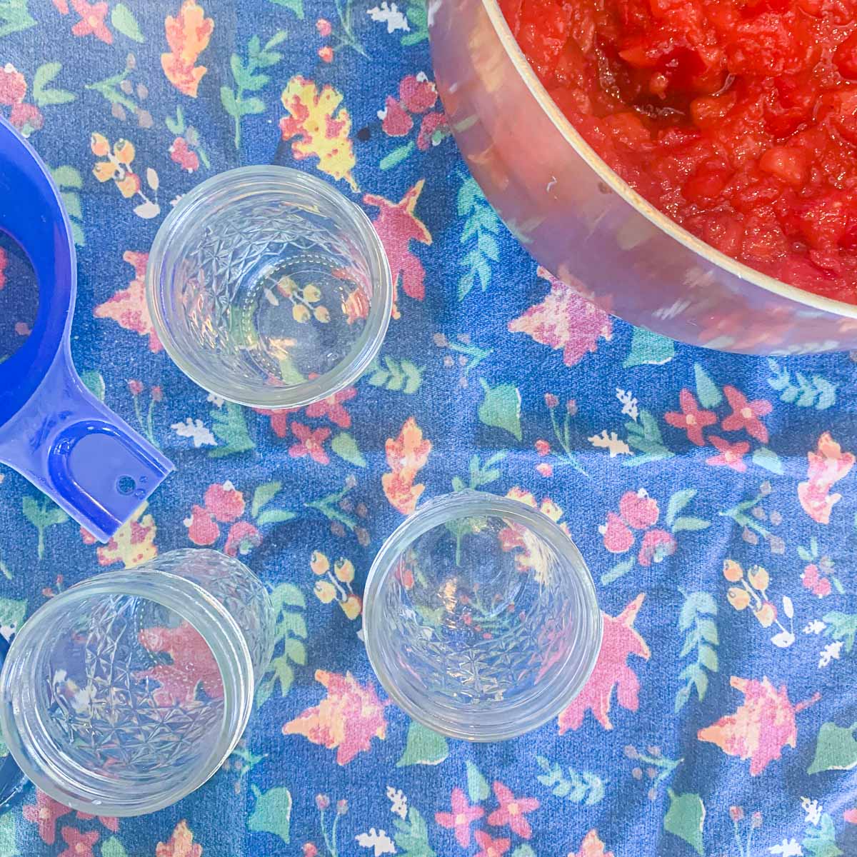 empty mason jars with a pot of jam