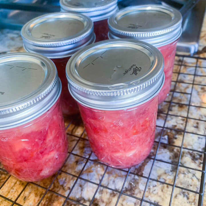 cans of jam cooling on the counter