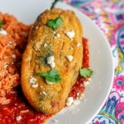 Chile relleno on a white plate with rice